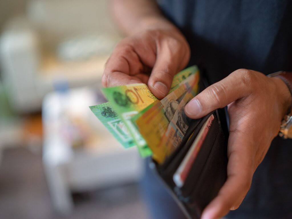Australian dollar bills in man's wallet